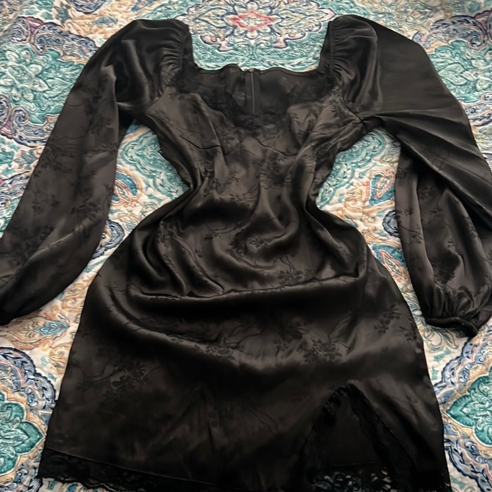 Figure hugging dress, black with lace detailing on the edges.